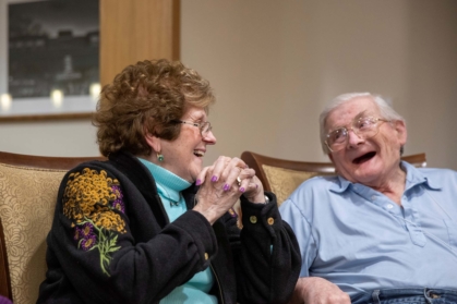 Male and female senior talking and laughing