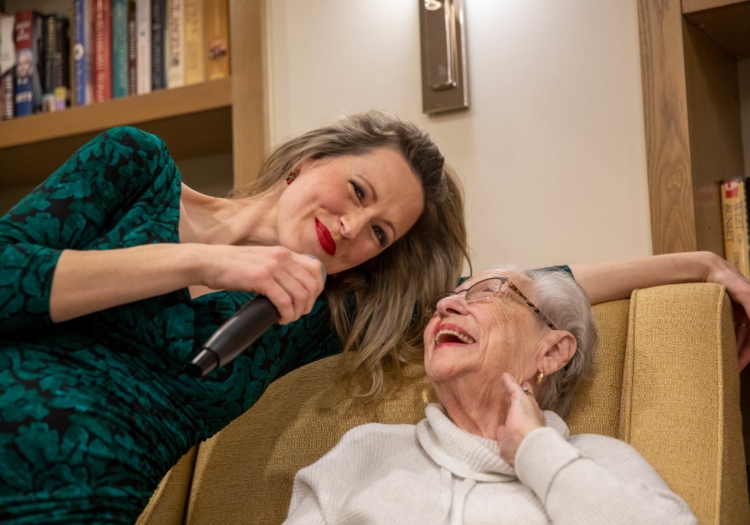 Performer singing with a resident