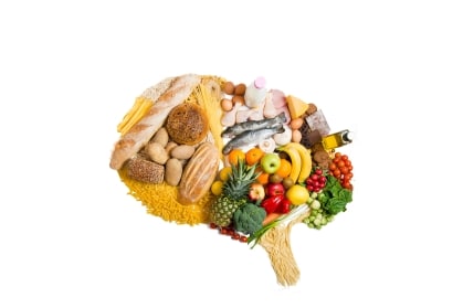 Silhouette of human brain made of brain-healthy foods for seniors, including leafy greens, fatty fish, berries, walnuts, whole grains, and vegetables.